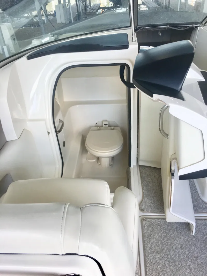 Slide: The Image of White leather seat on a 2006 Sea Ray 270 SLX boat interior. - 6