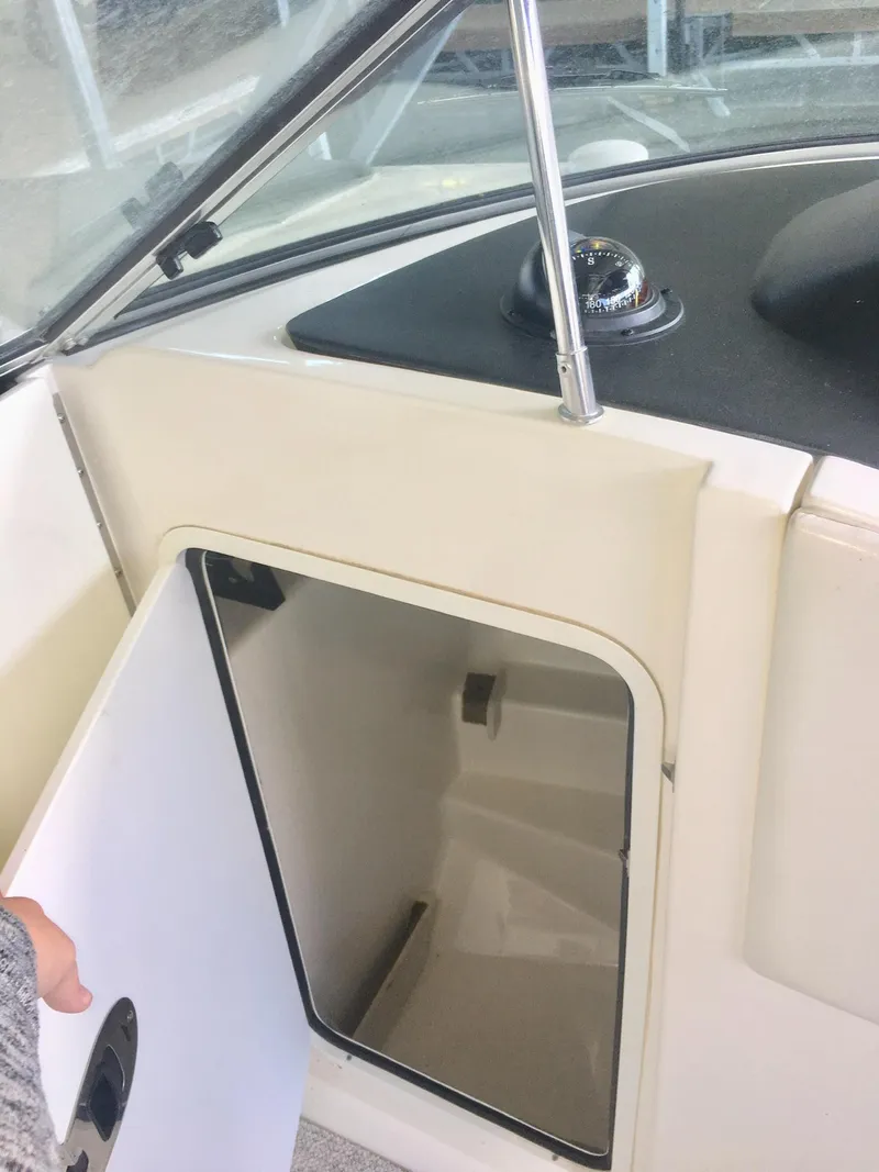 Slide: The Image of 2006 Sea Ray 270 SLX boat interior with white seating and steering wheel. - 7