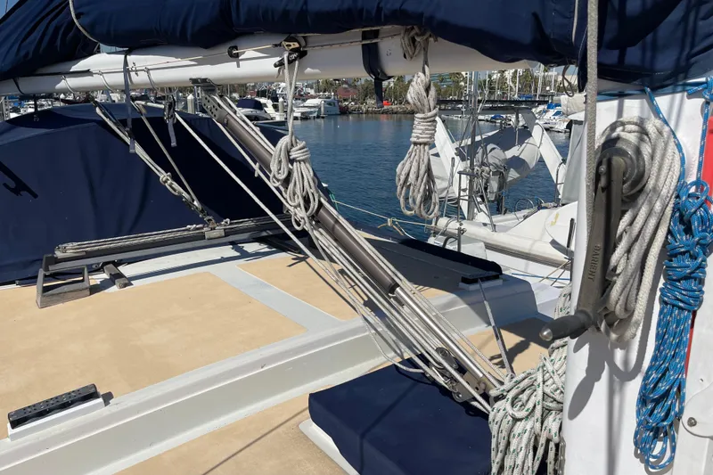 Slide: The Image of 1978 Downeast 38 sailboat deck with rigging and ropes in a marina setting. - 14