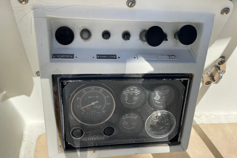 Slide: The Image of Control panel of a 1978 Downeast 38 boat with gauges and switches. - 17