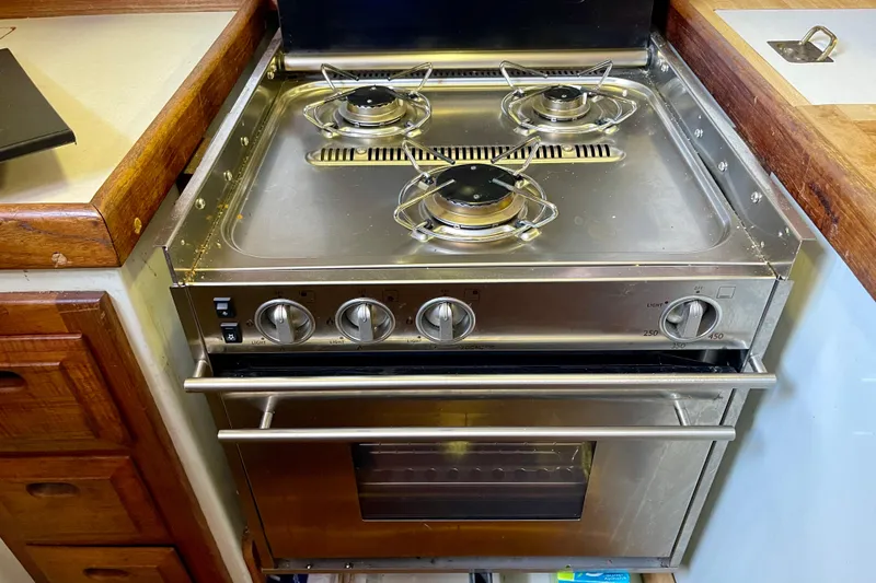 Slide: The Image of Stainless steel stove and oven in a 1978 Downeast 38 boat kitchen. - 23