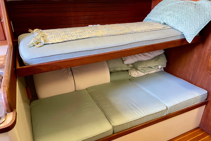 Slide: The Image of 1978 Downeast 38 boat interior with bunk beds and light blue cushions. - 28