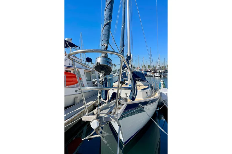 Slide: The Image of 1978 Downeast 38 sailboat docked in marina, clear blue sky background. - 3