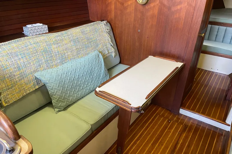 Slide: The Image of Interior of 1978 Downeast 38 boat with wooden paneling and cozy seating area. - 30