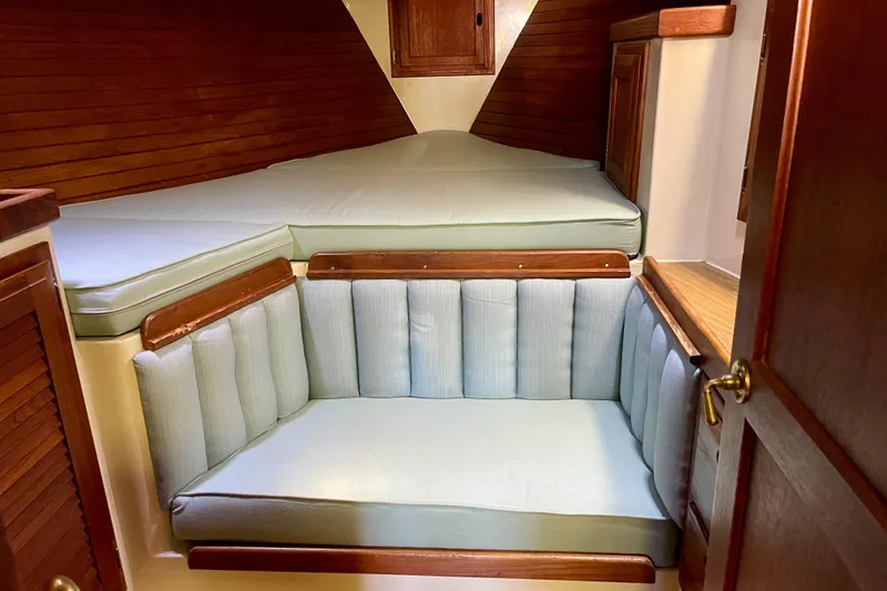 Slide: The Image of 1978 Downeast 38 boat interior with cushioned seating and wooden accents. - 33