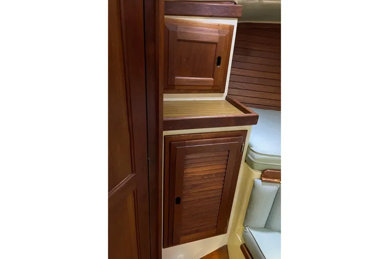 Slide: The Image of 1978 Downeast 38 yacht interior with wooden cabinets and seating area. - 35