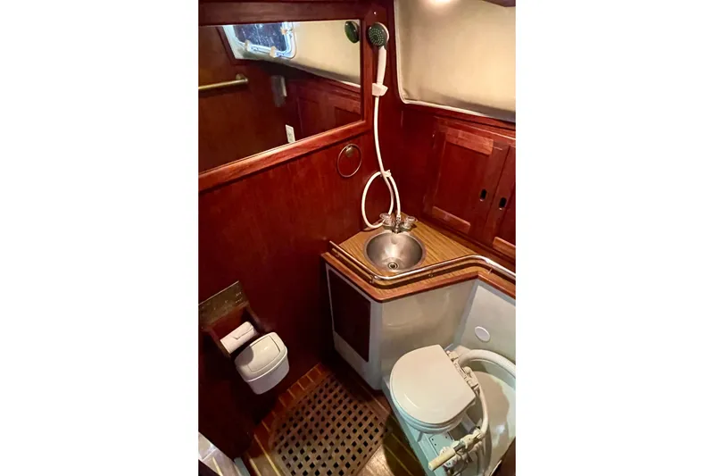 Slide: The Image of 1978 Downeast 38 yacht bathroom with wooden cabinetry, sink, and toilet. - 38