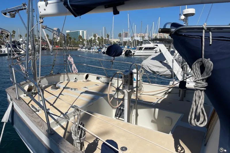 Slide: The Image of 1978 Downeast 38 sailboat docked in marina, featuring spacious deck and rigging. - 9
