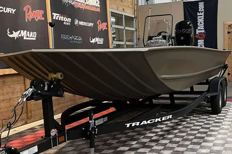 Slide: The Image of 2026 Tracker Grizzly 2072 CC boat on trailer in showroom setting. - 6