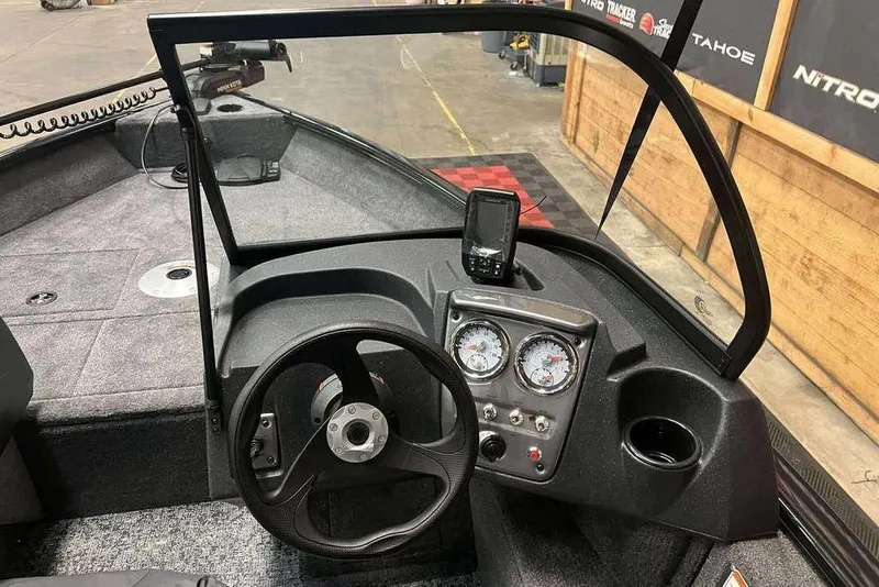 Slide: The Image of 2026 Tracker Pro Guide V-16 WT boat dashboard with steering wheel and gauges. - 6