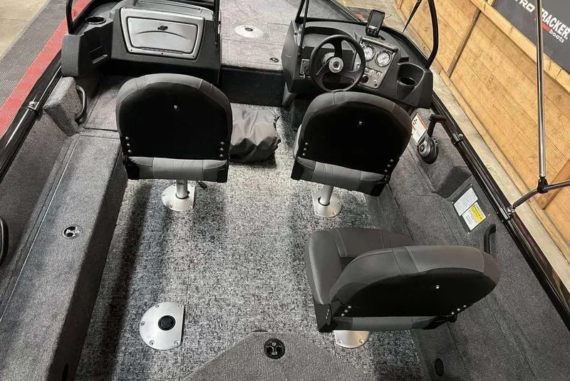Slide: The Image of 2026 Tracker Pro Guide V-16 WT boat interior with seating and steering console. - 7