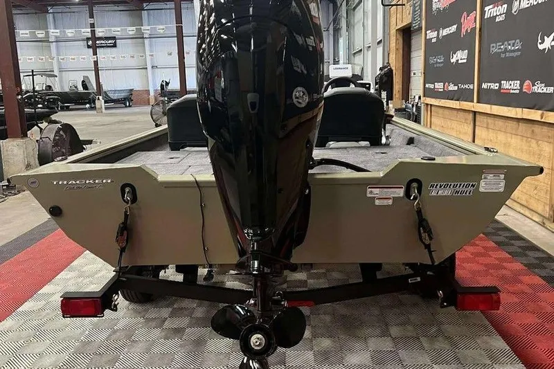 Slide: The Image of 2026 Tracker Pro Team 175 boat in showroom, rear view with motor. - 5