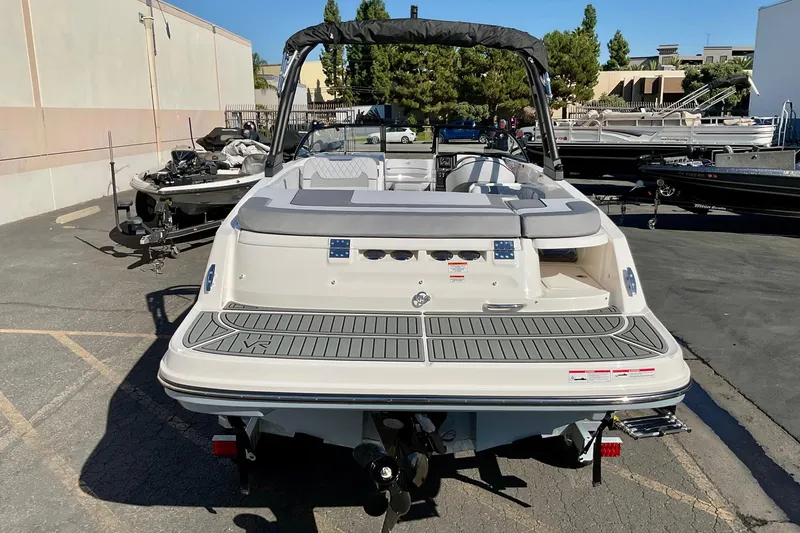 Slide: The Image of 2026 Bayliner VR6 Bowrider I/O boat, rear view in a parking lot. - 16