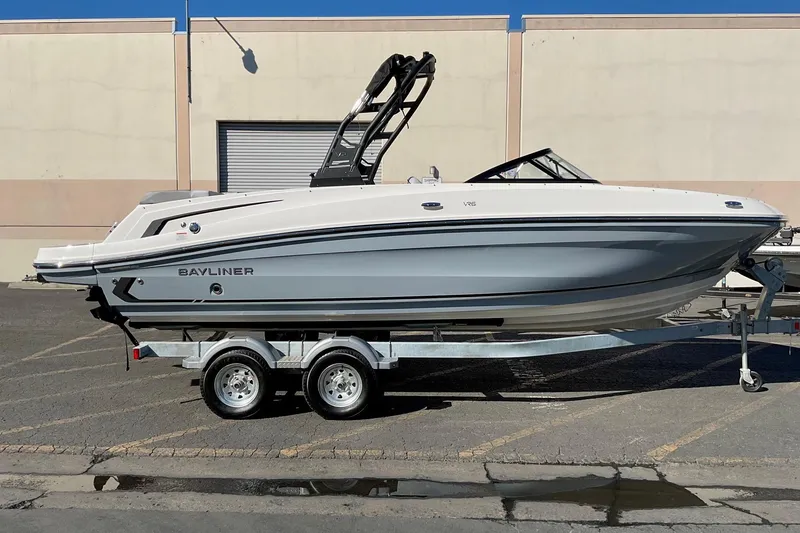 Slide: The Image of 2026 Bayliner VR6 Bowrider I/O on trailer, parked outdoors. - 2