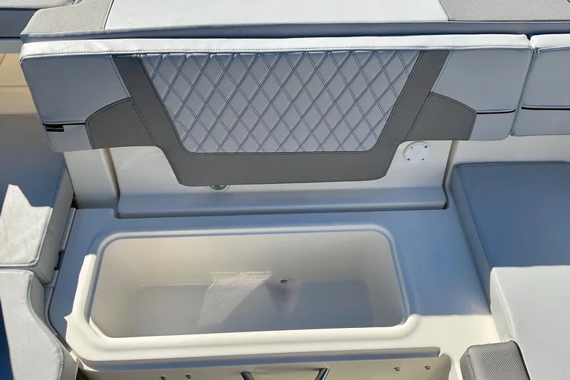 Slide: The Image of 2026 Bayliner VR6 Bowrider I/O interior with cushioned seating and storage compartment. - 23
