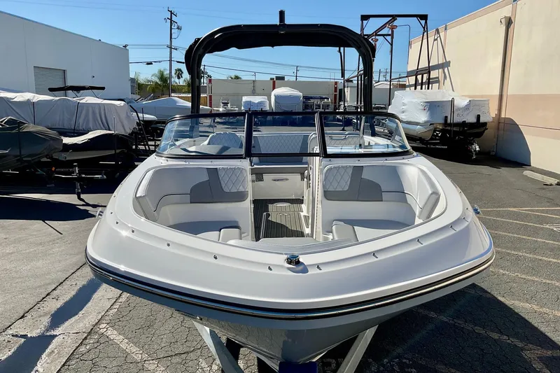 Slide: The Image of 2026 Bayliner VR6 Bowrider I/O boat in a parking lot, front view. - 4