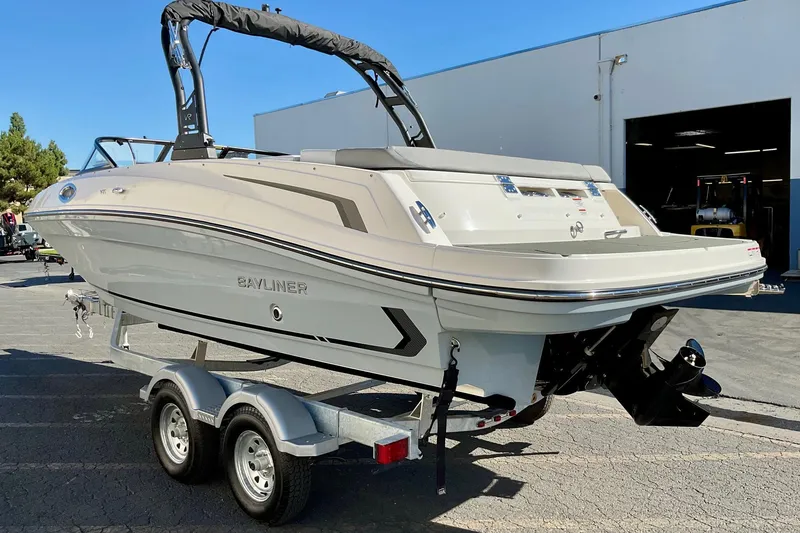 Slide: The Image of 2026 Bayliner VR6 Bowrider I/O on trailer, parked outdoors near a building. - 9
