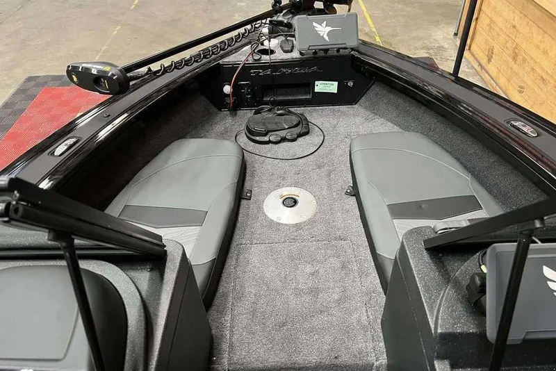 Slide: The Image of 2026 Tracker Targa V-19 Combo boat interior with gray seating and advanced controls. - 5