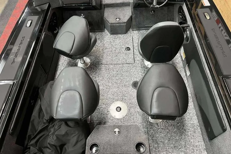 Slide: The Image of 2026 Tracker Targa V-19 Combo boat interior with four black seats and gray carpet. - 8