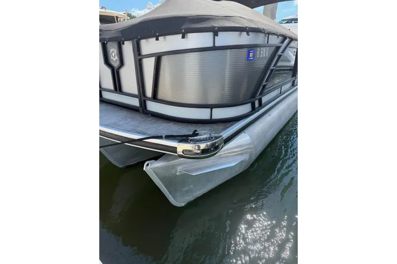 Slide: The Image of 2021 Godfrey Monaco 255 SFL pontoon boat docked on calm water. - 3