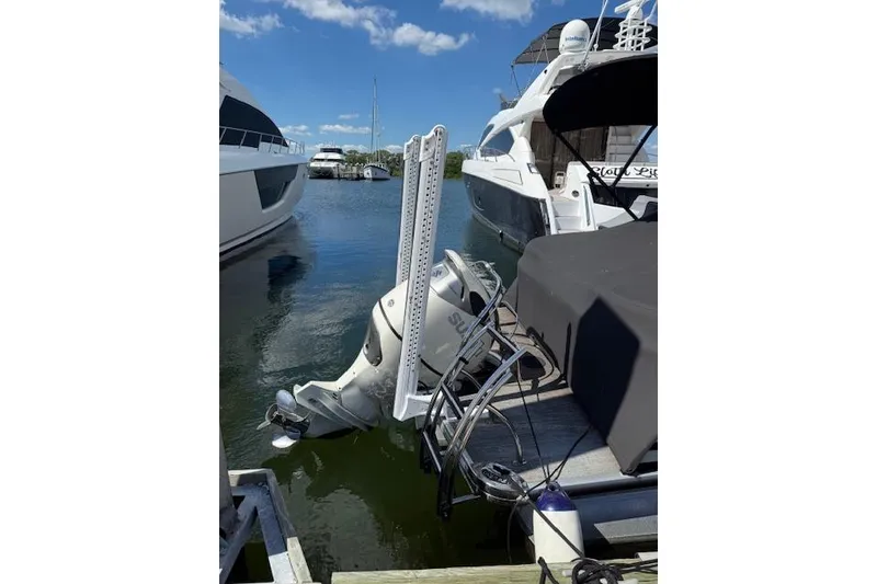 Slide: The Image of 2021 Godfrey Monaco 255 SFL boat docked with Suzuki outboard motor. - 4