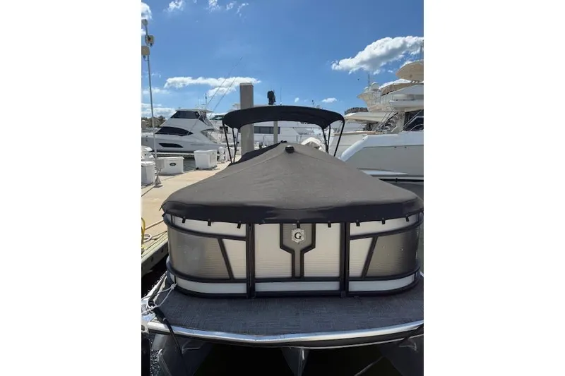 Slide: The Image of 2021 Godfrey Monaco 255 SFL pontoon boat docked under a clear blue sky. - 5