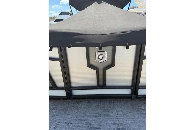 Slide: The Image of 2021 Godfrey Monaco 255 SFL pontoon boat with canopy and logo detail. - 6