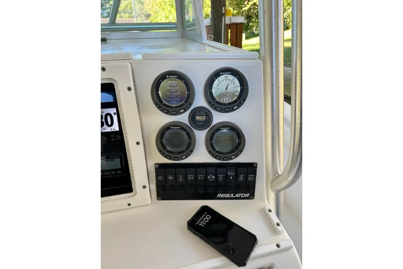 Slide: The Image of 2005 Regulator 26 Center Console dashboard with gauges and controls. - 10