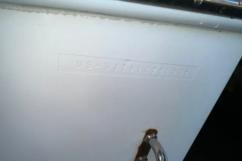 Slide: The Image of 2005 Regulator 26 Center Console hull identification number on white surface. - 14