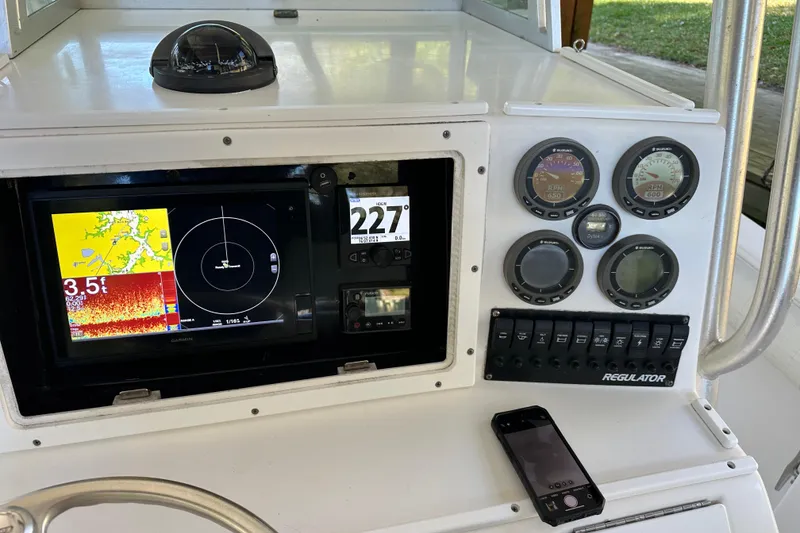 Slide: The Image of 2005 Regulator 26 Center Console dashboard with navigation and control instruments. - 16