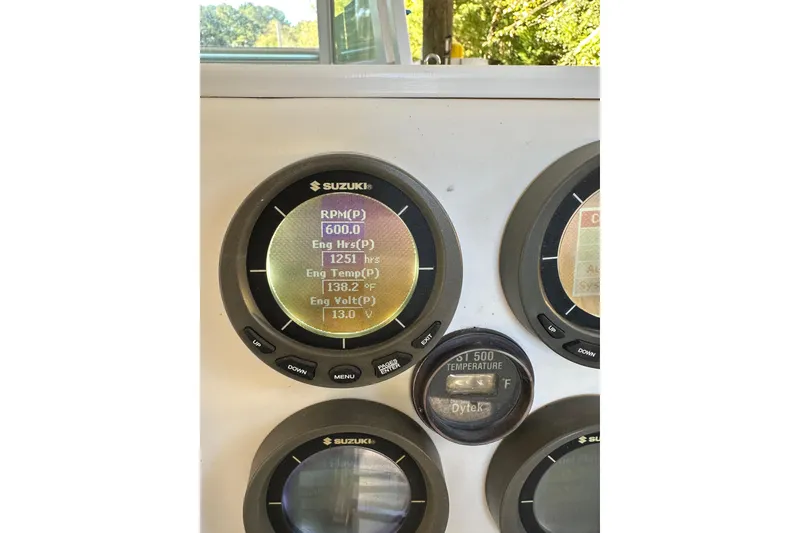 Slide: The Image of Close-up of Suzuki engine gauges on a 2005 Regulator 26 Center Console boat. - 17