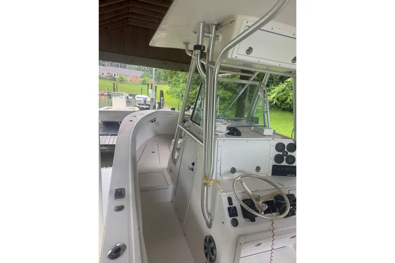 Slide: The Image of 2005 Regulator 26 Center Console boat interior with steering wheel and control panel. - 22