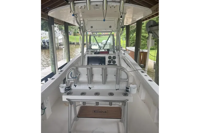 Slide: The Image of 2005 Regulator 26 Center Console boat interior with fishing rod holders and control panel. - 24