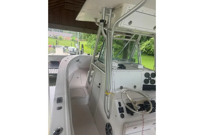 Slide: The Image of 2005 Regulator 26 Center Console boat interior with steering wheel and control panel. - 29