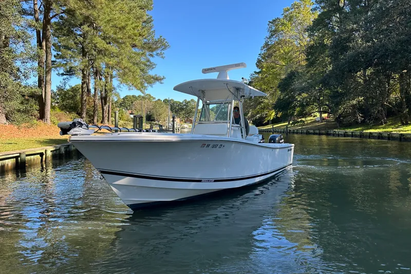 Slide: The Image of 2005 Regulator 26 Center Console boat cruising on a scenic waterway. - 4