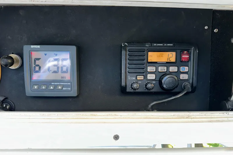 Slide: The Image of 2005 Regulator 26 Center Console dashboard with marine electronics and temperature display. - 8