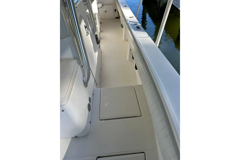 Slide: The Image of 2005 Regulator 26 Center Console boat interior with seating and storage compartments. - 9
