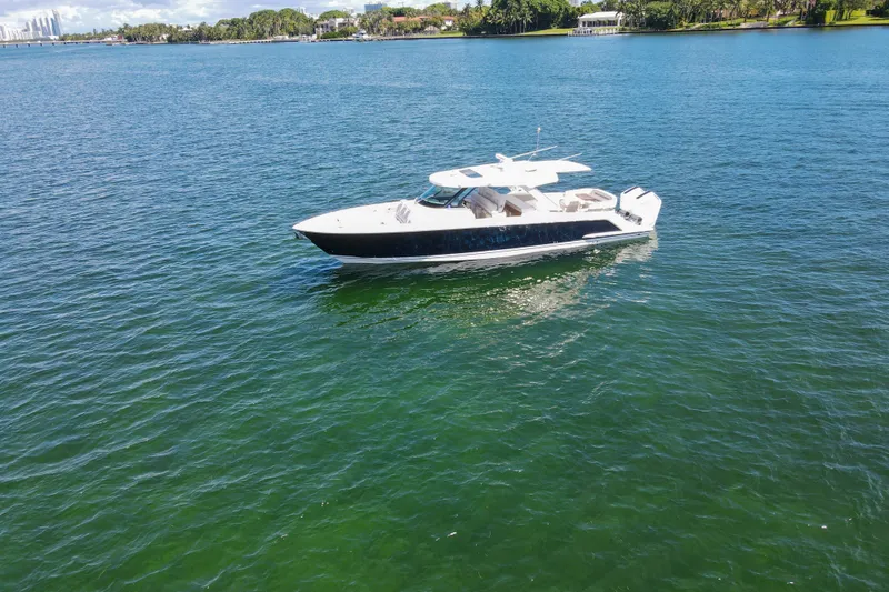 Slide: The Image of 2024 Tiara Yachts 43 LS cruising on clear blue water. - 12