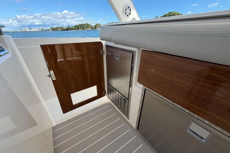Slide: The Image of 2024 Tiara Yachts 43 LS interior with wood accents and stainless steel appliances. - 22