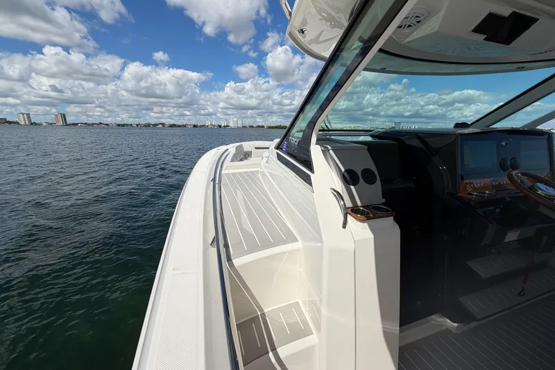 Slide: The Image of 2024 Tiara Yachts 43 LS on open water, showcasing sleek design and modern cockpit. - 25