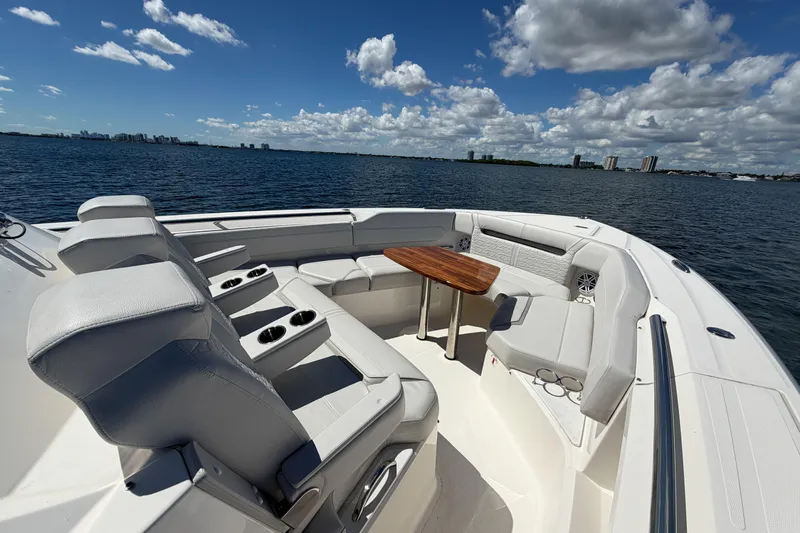 Slide: The Image of 2024 Tiara Yachts 43 LS luxury boat interior with seating and table, on a sunny day. - 31