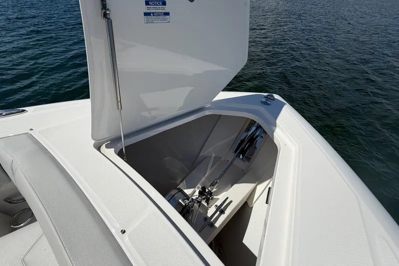 Slide: The Image of 2024 Tiara Yachts 43 LS anchor compartment open on calm water. - 33