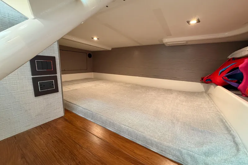 Slide: The Image of 2024 Tiara Yachts 43 LS cabin interior with bed and modern lighting. - 36