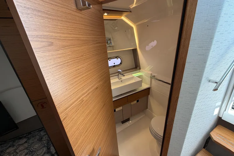 Slide: The Image of Luxurious bathroom interior of 2024 Tiara Yachts 43 LS, featuring modern fixtures and wood accents. - 37