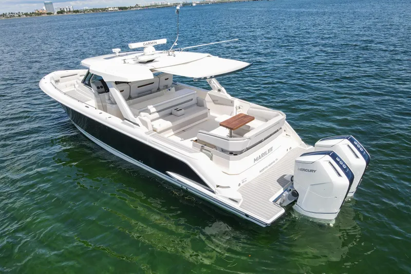 Slide: The Image of 2024 Tiara Yachts 43 LS boat on water with twin Mercury engines. - 7