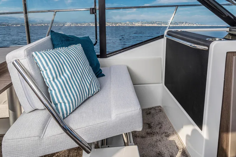 Slide: The Image of Interior of 2026 Jeanneau NC 895 Series 2 boat with striped cushions and ocean view. - 15