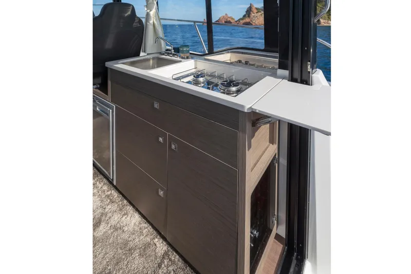 Slide: The Image of 2026 Jeanneau NC 895 Series 2 boat kitchen with ocean view, featuring modern appliances. - 16