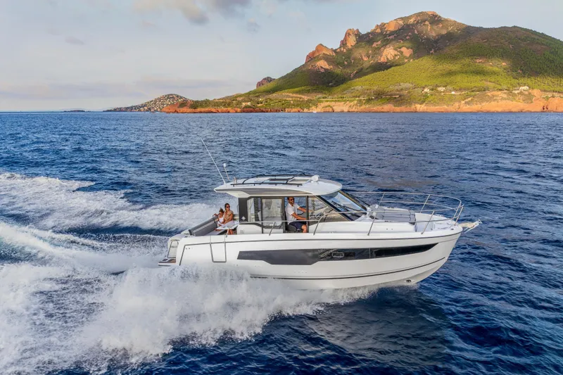 Slide: The Image of 2026 Jeanneau NC 895 Series 2 cruising on ocean near scenic coastline. - 2