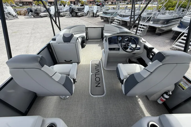 Slide: The Image of 2025 Avalon 2385 LSZ Quad Lounger interior with modern seating and steering console. - 11