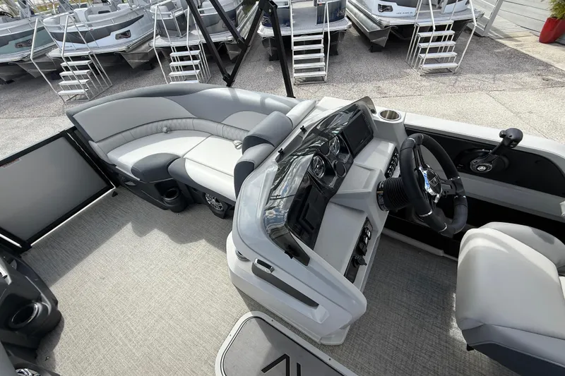 Slide: The Image of 2025 Avalon 2385 LSZ Quad Lounger interior with modern helm and seating. - 12